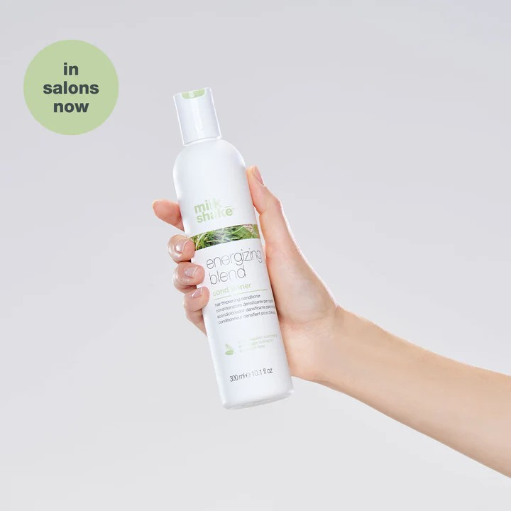 Milk_Shake Energizing Blend Conditioner model holding bottle