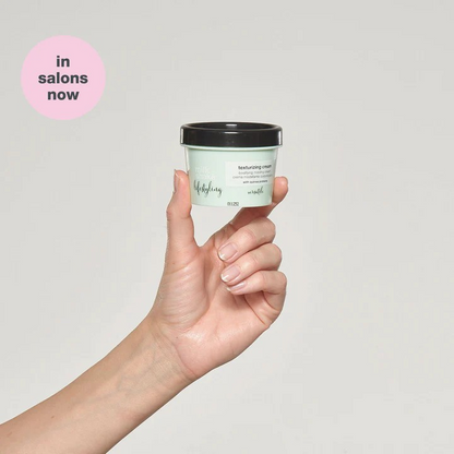 Milk_Shake Lifestyling Texturizing Cream model holding product